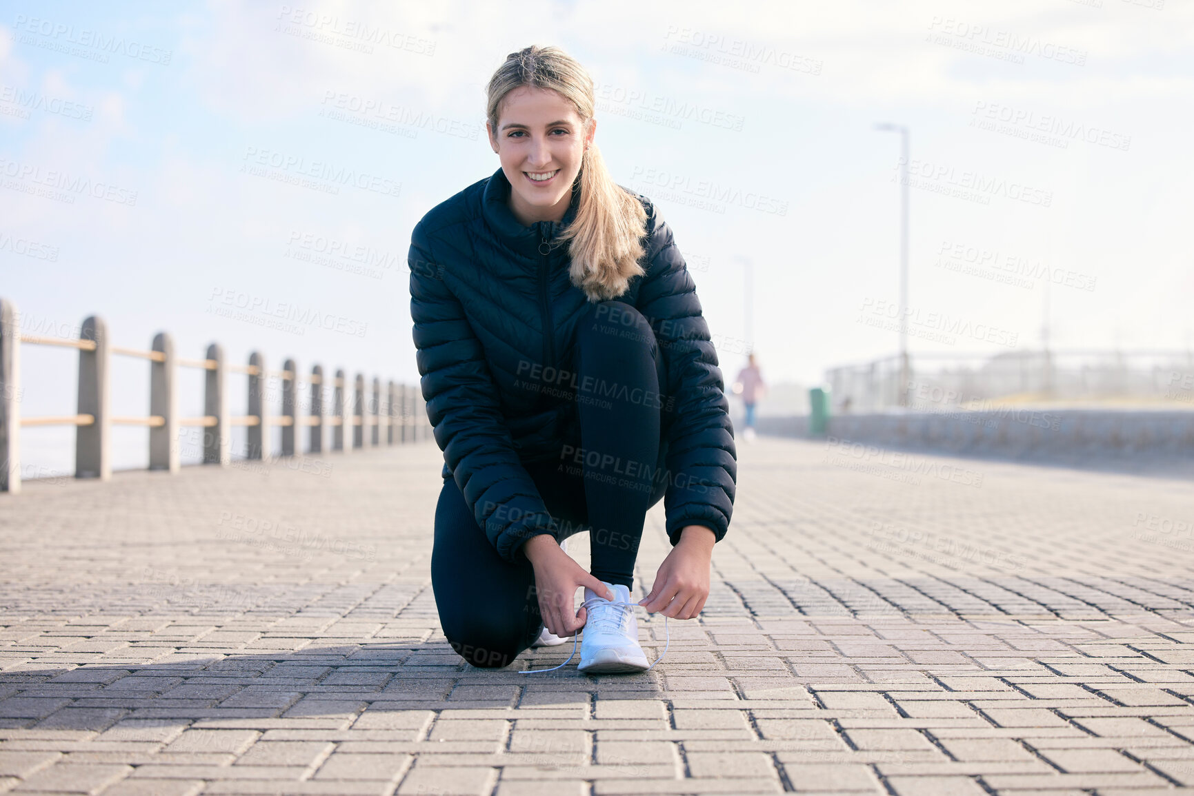 Buy stock photo Portrait, shoelace and happy woman runner at beach with performance, preparation or warm up. Fitness, shoes and face of girl with positive, mindset or smile before run, training and workout exercise