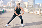 Exercise, woman and stretching at the beach for training, running and morning cardio routine outdoors. Runner, warm up and girl stretch before fitness, sports and workout along the ocean in Miami