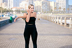 Woman, runner and stretching arms at the beach for training, running and morning cardio routine outdoors. Run, warm up and girl stretch before fitness, exercise and sports workout along the ocean