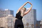 Rear view, woman and stretching arms outdoors for training, running and morning cardio routine. Back, warm up and girl stretch before fitness, exercise and sports workout, wellness and performance 