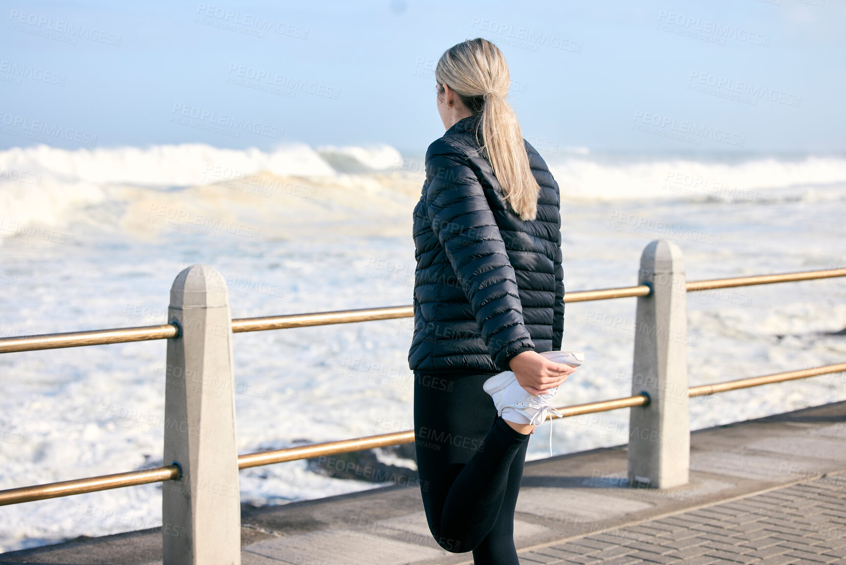 Buy stock photo Stretching legs, fitness and a woman at the beach for running, exercise and getting ready for cardio. Back, ocean and a runner preparing to train for sport or an outdoor workout with a warm up