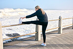 Fitness, woman and stretching legs at the beach for training, running and morning cardio routine outdoors. Runner, warm up and girl stretch before exercise, sports and performance workout at the sea