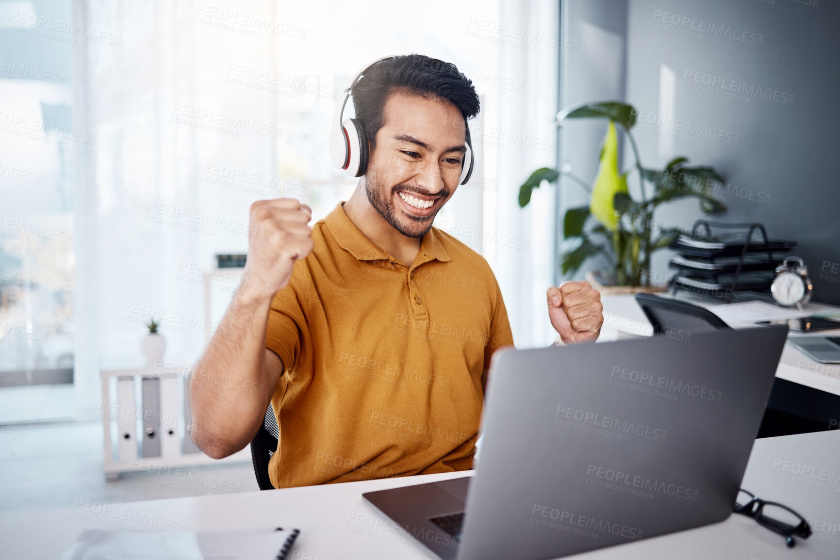 Buy stock photo Business man, laptop and success with headphones to listen to music, audio or video call. Asian male entrepreneur at desk with a smile and hands to celebrate achievement, online target or goals