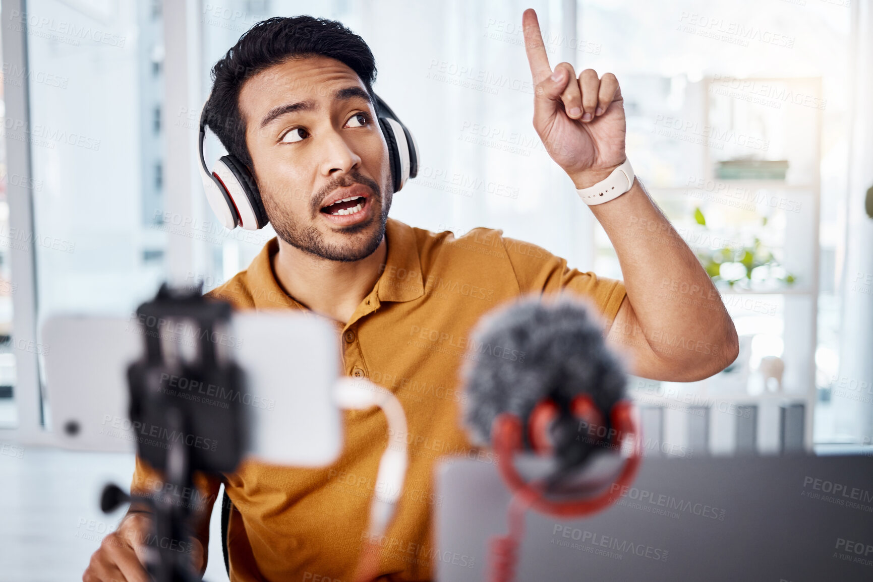 Buy stock photo Podcast, pointing and live stream with a man influencer recording broadcast content in his home office. Internet, freelance and subscription with a male vlogger or creator working in his studio