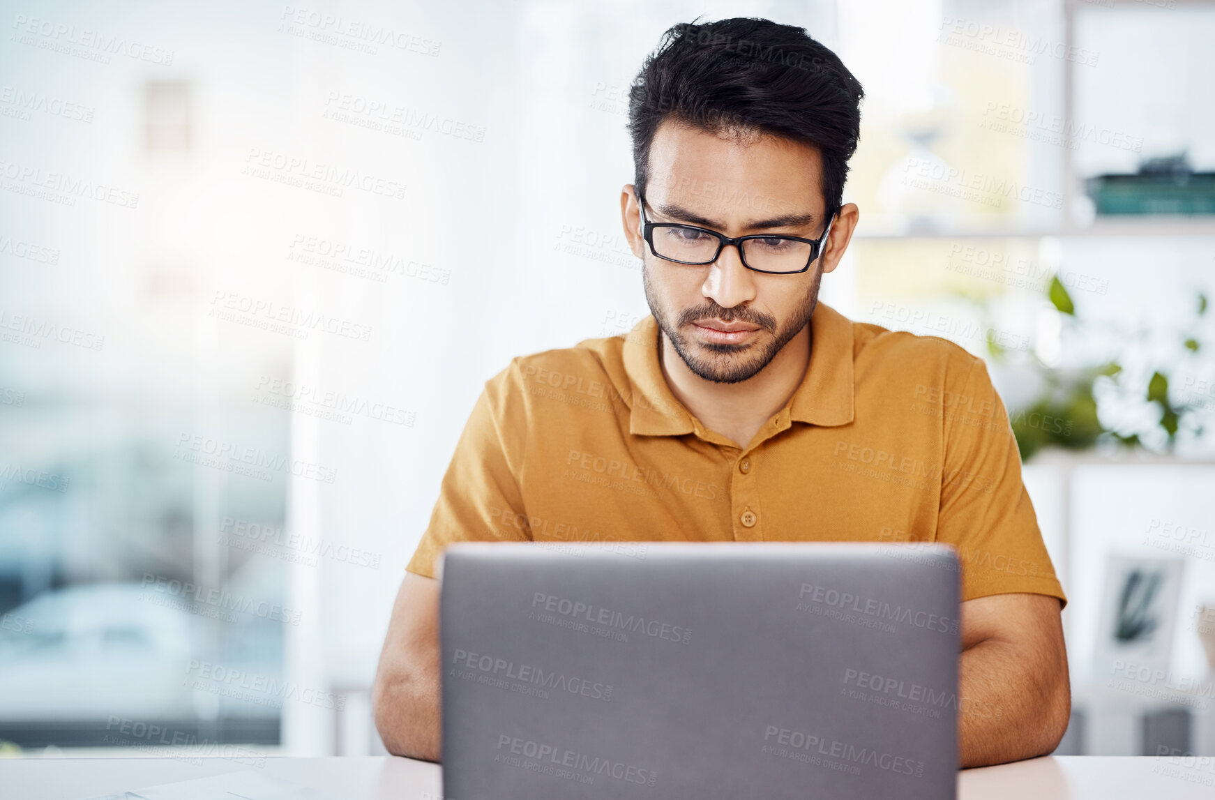 Buy stock photo Serious, work and an Asian man with a laptop in a home office for communication, email and internet. Business, research and an entrepreneur or freelance worker typing a proposal on a computer