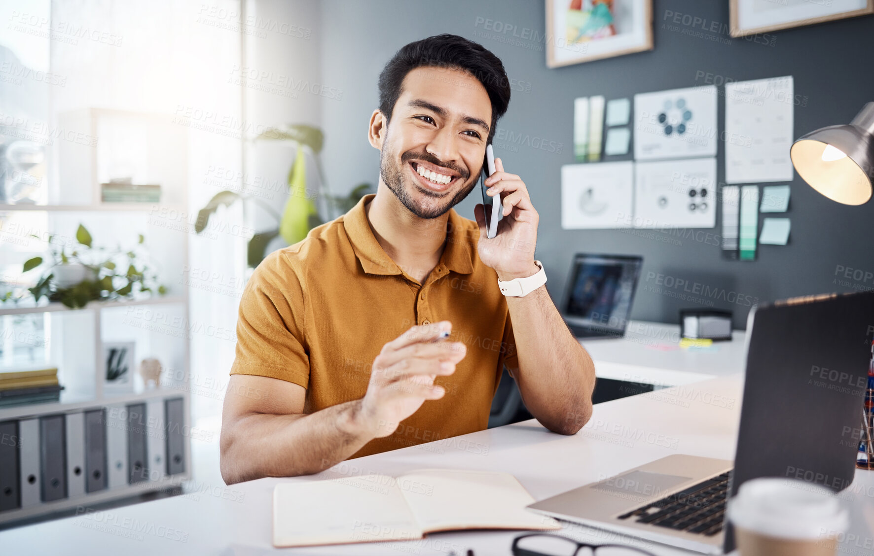 Buy stock photo Phone call, smile and planning with a business man chatting while working at his desk in the office. Mobile, contact and communication with a young male employee chatting or networking for strategy