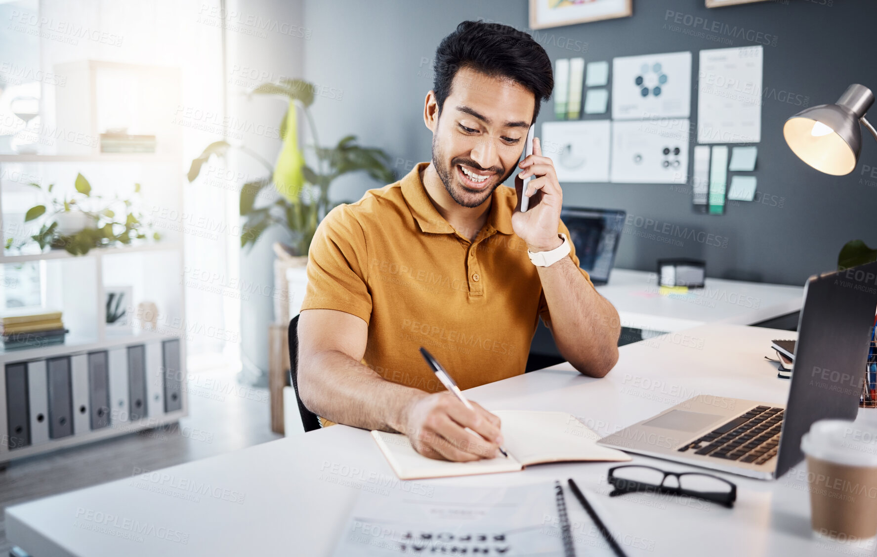 Buy stock photo Phone call, happy and Asian man writing notes for reminder, schedule and planning at office desk. Communication, business and male worker on smartphone talking, in discussion and consulting for help