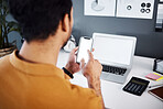 Man, phone and laptop with mockup screen for research, advertising or marketing at the office desk. Hand of male accountant working on smartphone and computer display with copy space at the workplace