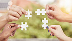 Closeup group of people, hands and puzzle for teamwork, solution and problem solving for innovation. Team building game, jigsaw piece and collaboration of cooperation, synergy or planning integration