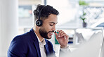 Customer service, support and communication with a consultant man using a headset while working in an office. Contact us, crm and consulting with a happy young male employee at work in a call center