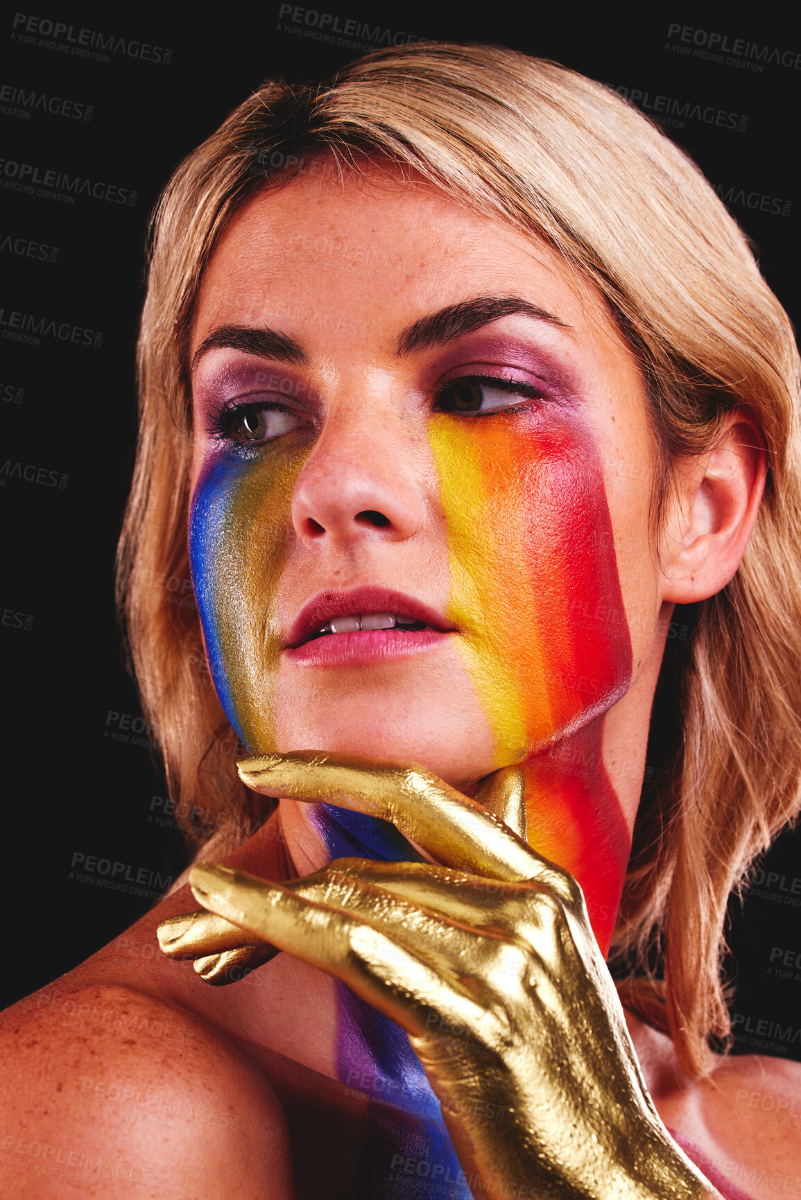 Buy stock photo Woman, gold hand and beauty with color paint cosmetics on skin and face in studio. Female model person on a black background for art deco, fantasy and creative rainbow makeup for lgbtq or gay pride