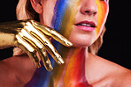 Woman, gold hand and beauty with color, paint or cosmetics on skin and face in studio. Female model person on a black background for art deco, fantasy and creative rainbow makeup or metallic closeup