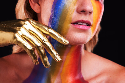 Buy stock photo Woman, gold hand and beauty with color, paint or cosmetics on skin and face in studio. Female model person on a black background for art deco, fantasy and creative rainbow makeup or metallic closeup