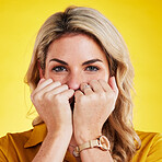 Embarrassed, portrait and woman with fist on face in studio isolated on a yellow background. Female person, introvert and covering mouth with hands, peek and hiding, secret and shy with gossip.
