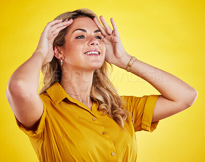 Buy stock photo Happy, thinking and a woman fixing hair isolated on a yellow background in a studio for grooming. Smile, idea and a young girl looking confident touching hairstyle for appearance and happiness