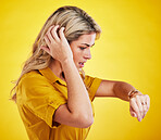 Watch, late and woman checking the time in a studio with a shock, scared and surprise face expression. Panic, anxiety and confused female model with a wristwatch isolated by a yellow background.