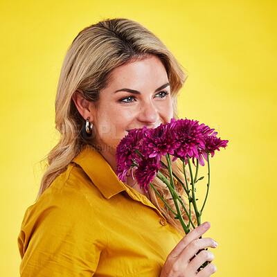 Buy stock photo Portrait, smile and woman smelling flowers in studio isolated on a yellow background. Floral, bouquet and happiness of person sniffing or female model with scent of natural plants and dahlia aroma.