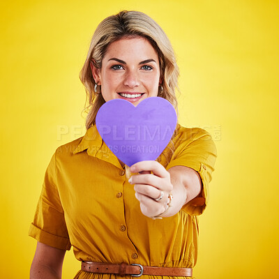 Buy stock photo Portrait, cut out heart and woman with support, smile and wellness against a studio background. Face, female person and model with a symbol for love, paper and sign with happiness, romance and loving