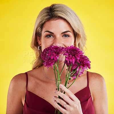 Buy stock photo Portrait, smell and woman with flowers, beauty and confident girl against a studio background. Face, female person and model with plants, natural care and floral present with lady, bouquet and scent