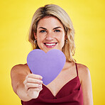 Portrait, cut out heart and woman with wellness, emoji and happiness against a studio background. Face, female model  and lady with a symbol for love, sign and support with smile, romantic and care
