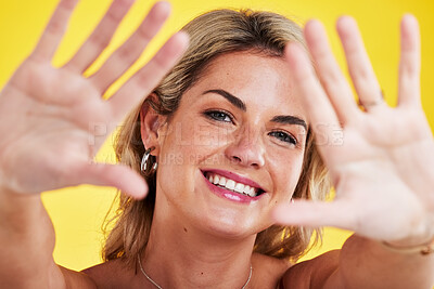 Fashion, frame and portrait of woman with hands on yellow background in trendy, stylish and modern clothes. Beauty, happiness and face of female person with palms up, confidence and happy in studio