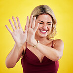 Fashion, laugh and woman with hands on yellow background in trendy, stylish and modern clothes. Laughing, happiness and face of isolated female person with palms up, confidence and happy in studio