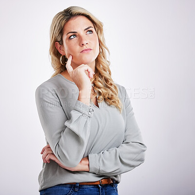 Buy stock photo Thinking, mind and problem solving with a woman on a gray background in studio for contemplation. Idea, choice and decision making with an attractive young female contemplating in thoughtful wonder