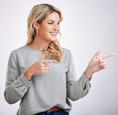 Buy stock photo Happy, woman and pointing to advertising at white background of offer, information and brand coming soon. Young female person, gesture and announcement of sales promotion, presentation and commercial