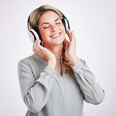 Buy stock photo Music, smile and happy woman in studio with headphones for audio track on grey background. Radio, relax and excited female with earphones for podcast, playlist and online, streaming and subscription
