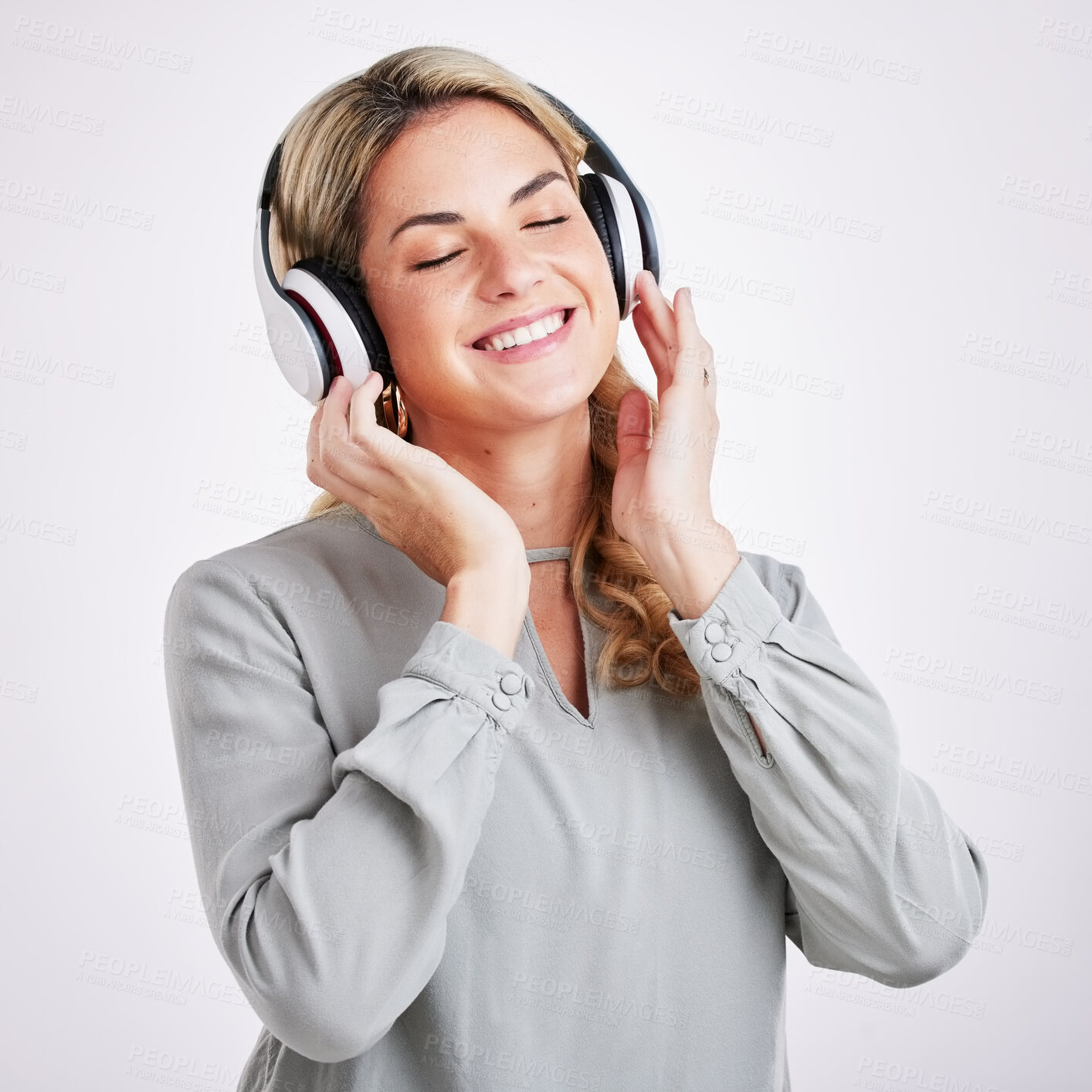 Buy stock photo Music, smile and happy woman in studio with headphones for audio track on grey background. Radio, relax and excited female with earphones for podcast, playlist and online, streaming and subscription