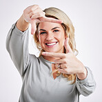 Happy woman, hands and frame for portrait selfie, photo or profile picture against a white studio background. Female framing face and smiling in focus for perfect photography, social media or capture