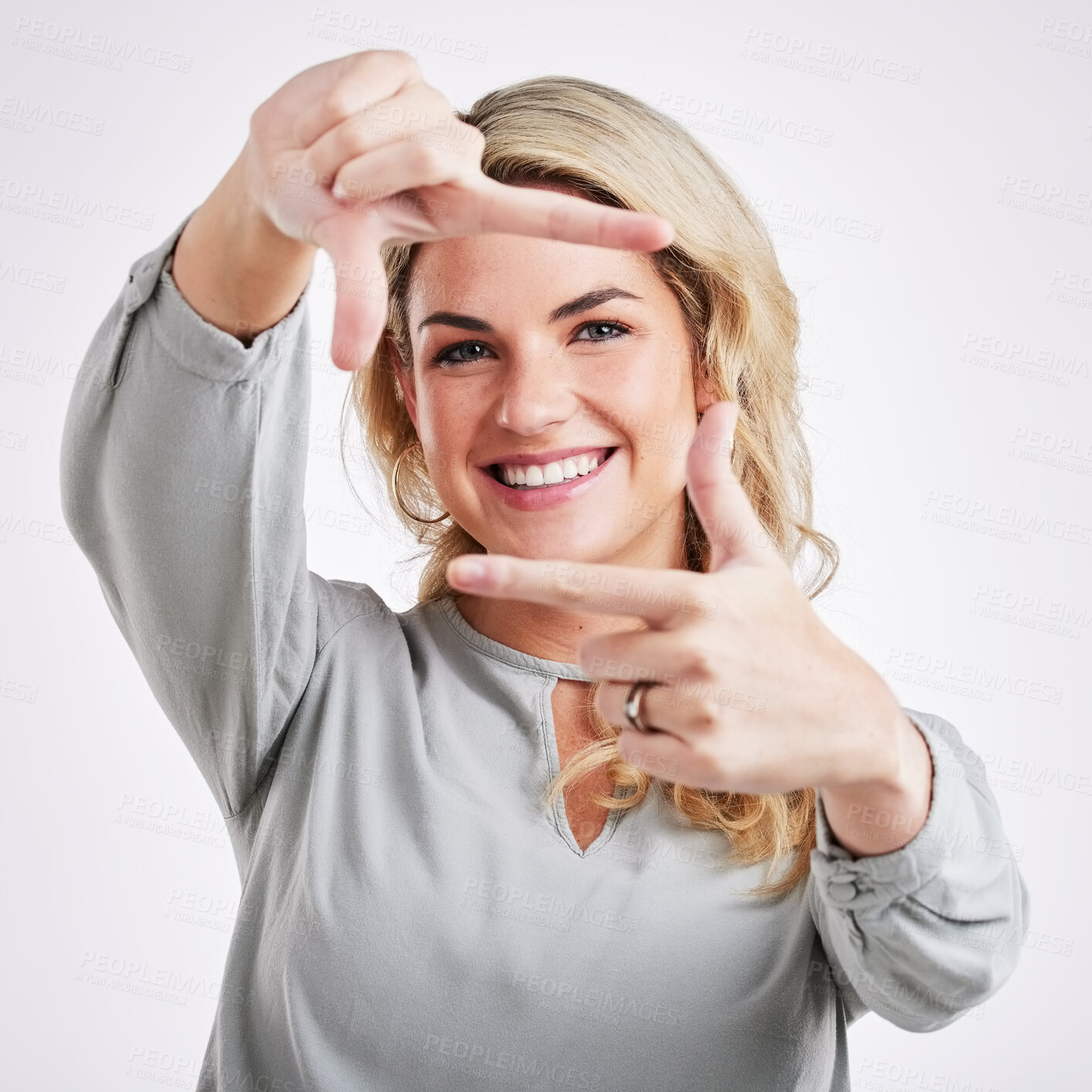 Buy stock photo Happy woman, hands and frame for portrait selfie, photo or profile picture against a white studio background. Female border face and smiling in focus for perfect photography, social media or capture