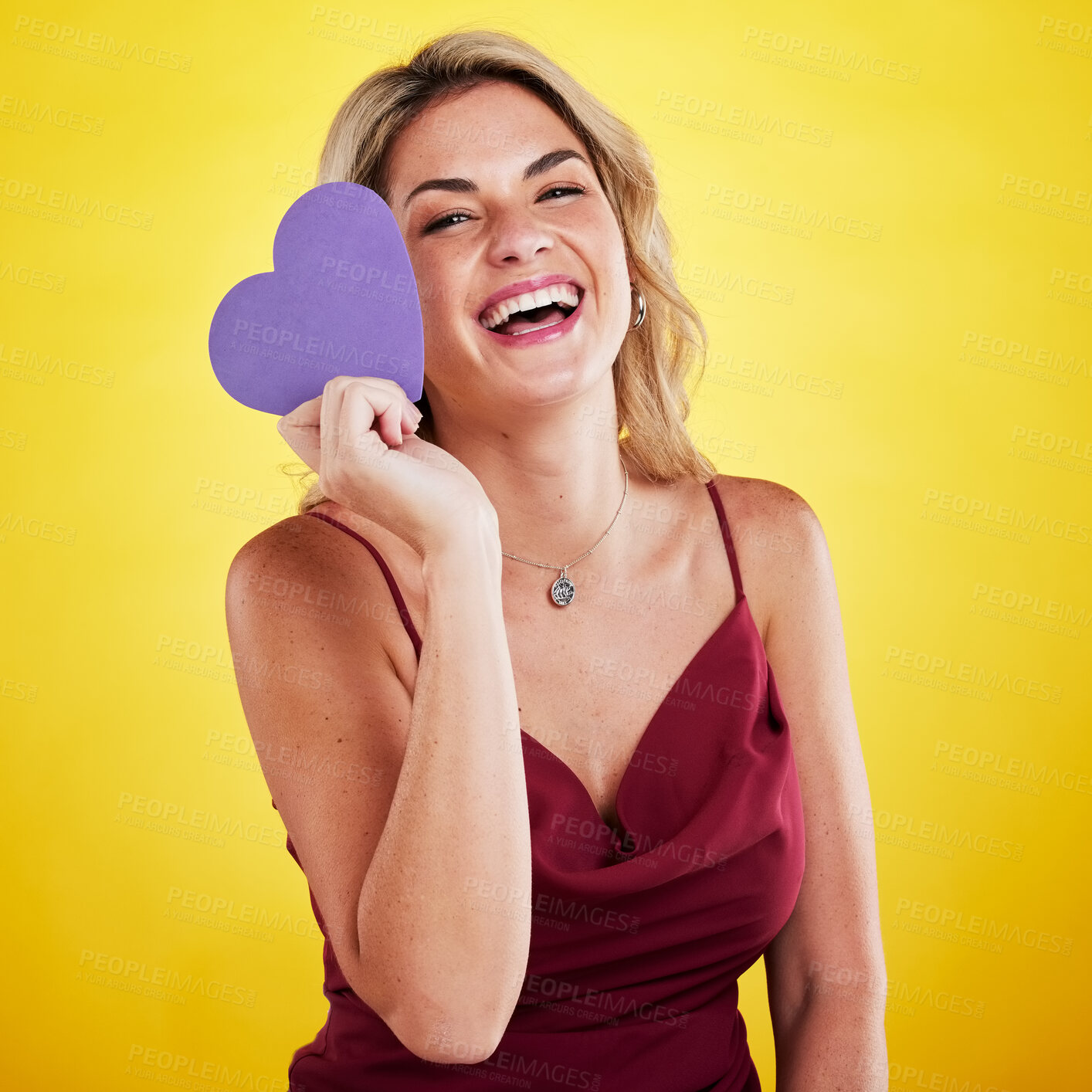 Buy stock photo Portrait, paper heart and woman with humor, care and female person against a studio background. Face, lady and happy model with a symbol for love, laughing and sign with happiness, hope and loving