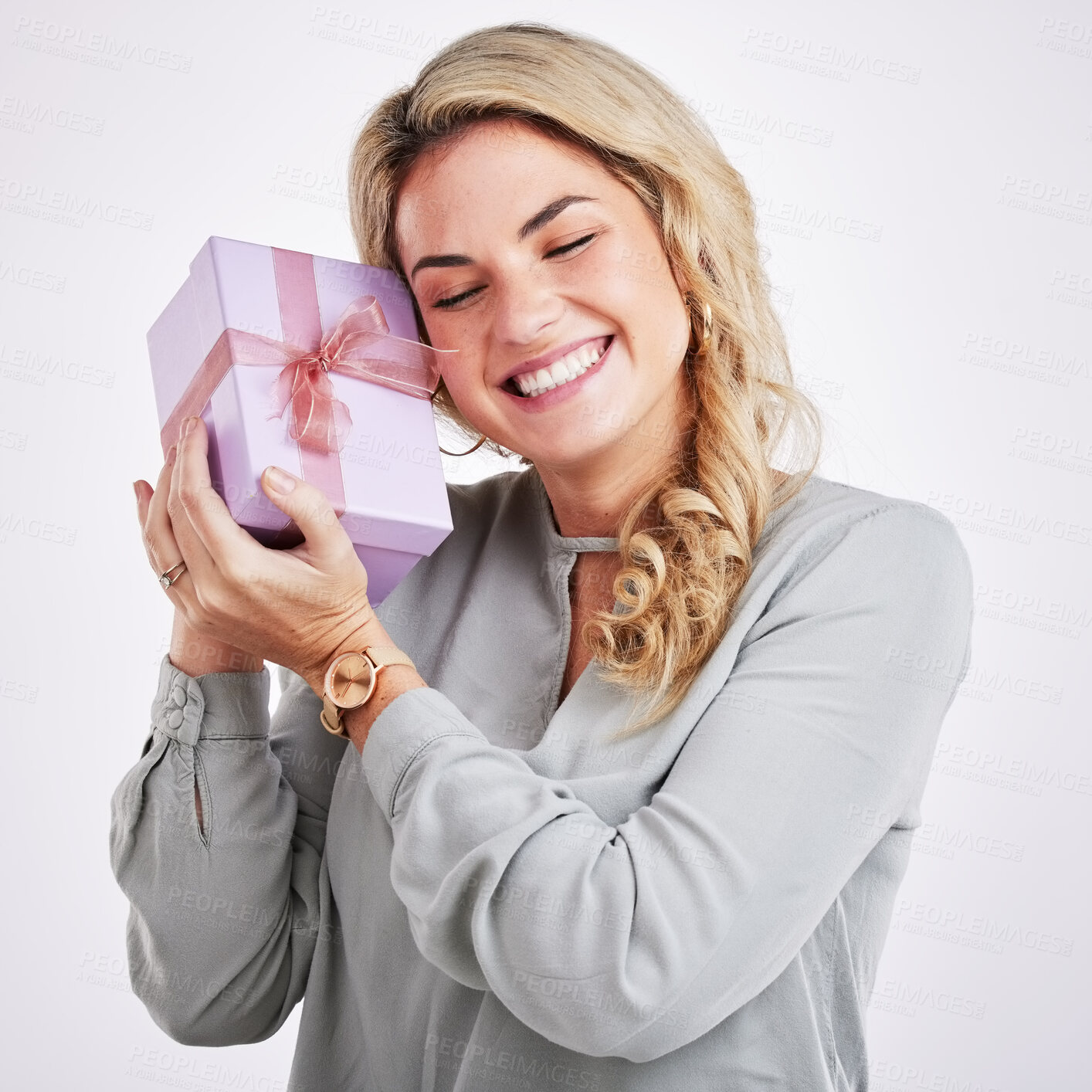 Buy stock photo Happy, person and woman with a gift, surprise and special event with a winner against studio background. Female model, smile and lady with a present, celebration and excited with parcel and package