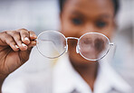 Vision, glasses in hand and woman in eye care clinic for health, wellness and poor sight exam with blur. Eyesight, girl holding designer brand frame and lens in hands, healthcare and test for eyes.