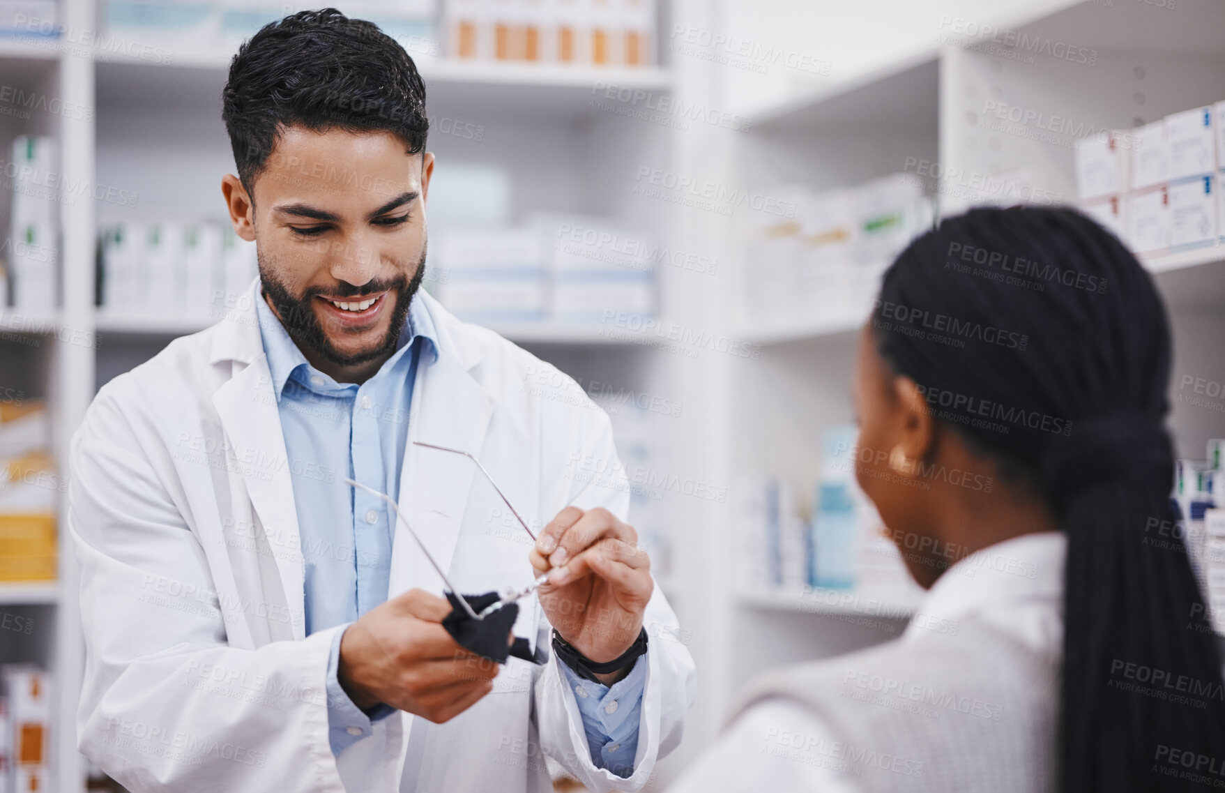 Buy stock photo Vision, lens or cleaning glasses for man in pharmacist work helping a customer at pharmacy shop. Cleaner, eyewear clean and happy healthcare worker in a retail store working at a clinic with a frame