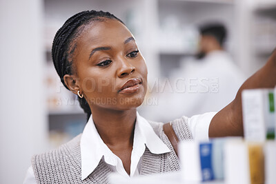 Buy stock photo Pharmacy stock, woman and medication check of a customer in a healthcare and wellness store. Medical, retail and pharmaceutical label information checking of an African female person by a shop shelf