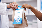 Clinic, medicine or pharmacist hands person a bag in drugstore with healthcare prescription receipt. Zoom, shopping or doctor giving customer products or pharmacy package for medical retail services