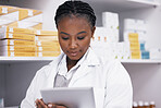 Black woman in pharmacy with tablet, online inventory list and prescription medicine on shelf. Female pharmacist reading digital checklist, advice and medical professional checking drugs in store.