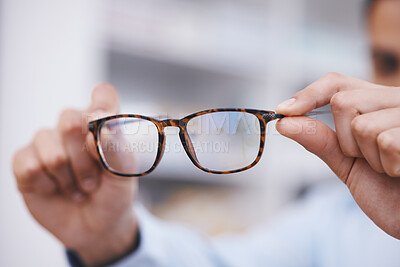 Buy stock photo Optometry, hands and optician with glasses for choice, eyesight and frame decision. Giving, showing and a man holding prescription eyewear for a fitting, vision and service during a consultation