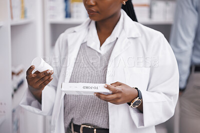 Buy stock photo Closeup, pharmacy or black woman with medicine, reading labels or wellness in a store. Zoom, female worker or pharmacist with medical products, healthcare or professional with supplements or vitamins