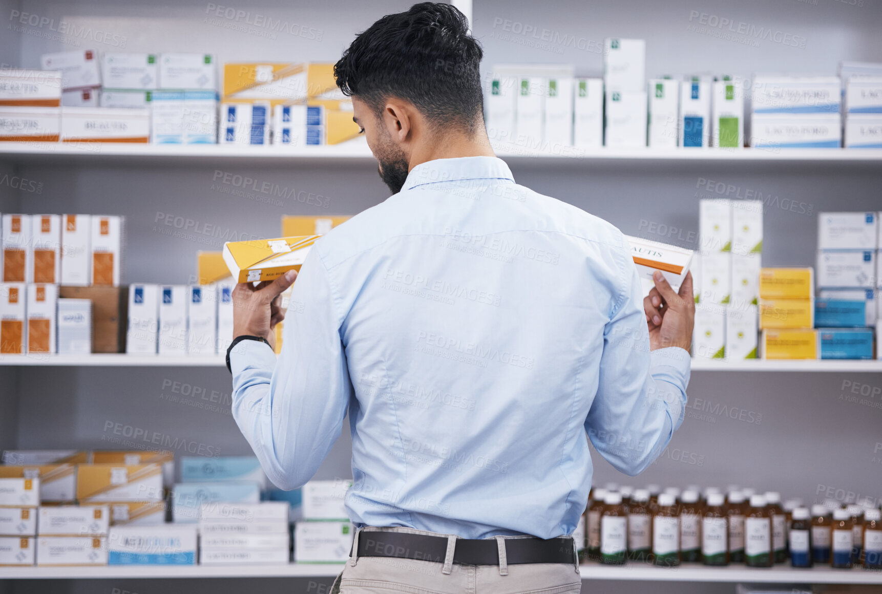Buy stock photo Pharmacy, medicine and man with pills choice for medication, prescription and treatment. Healthcare clinic, drug store and male person reading boxes for medical product, supplements and antibiotics