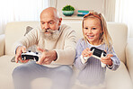 Grandpa, child and playing or gaming for entertainment with console controller in fun bonding on sofa at home. Happy grandfather and kid enjoying game, leisure or free time in living room together