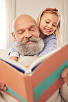 Grandfather, child and reading a story book in a family home for fun, happiness and learning. A senior man or grandpa and girl kid together for a fairytale, quality time and bonding while happy