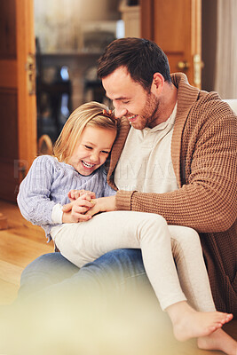 Buy stock photo Father, girl on lap and laughing in home, playing and bonding together. Dad, happiness and child or daughter laugh at funny joke, humor or comic comedy, having fun and enjoying quality time with care
