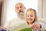 Grandfather, girl and family reading in a house with learning and child development at home. Books, story and education on a living room sofa with grandpa and kid together in a conversation with love