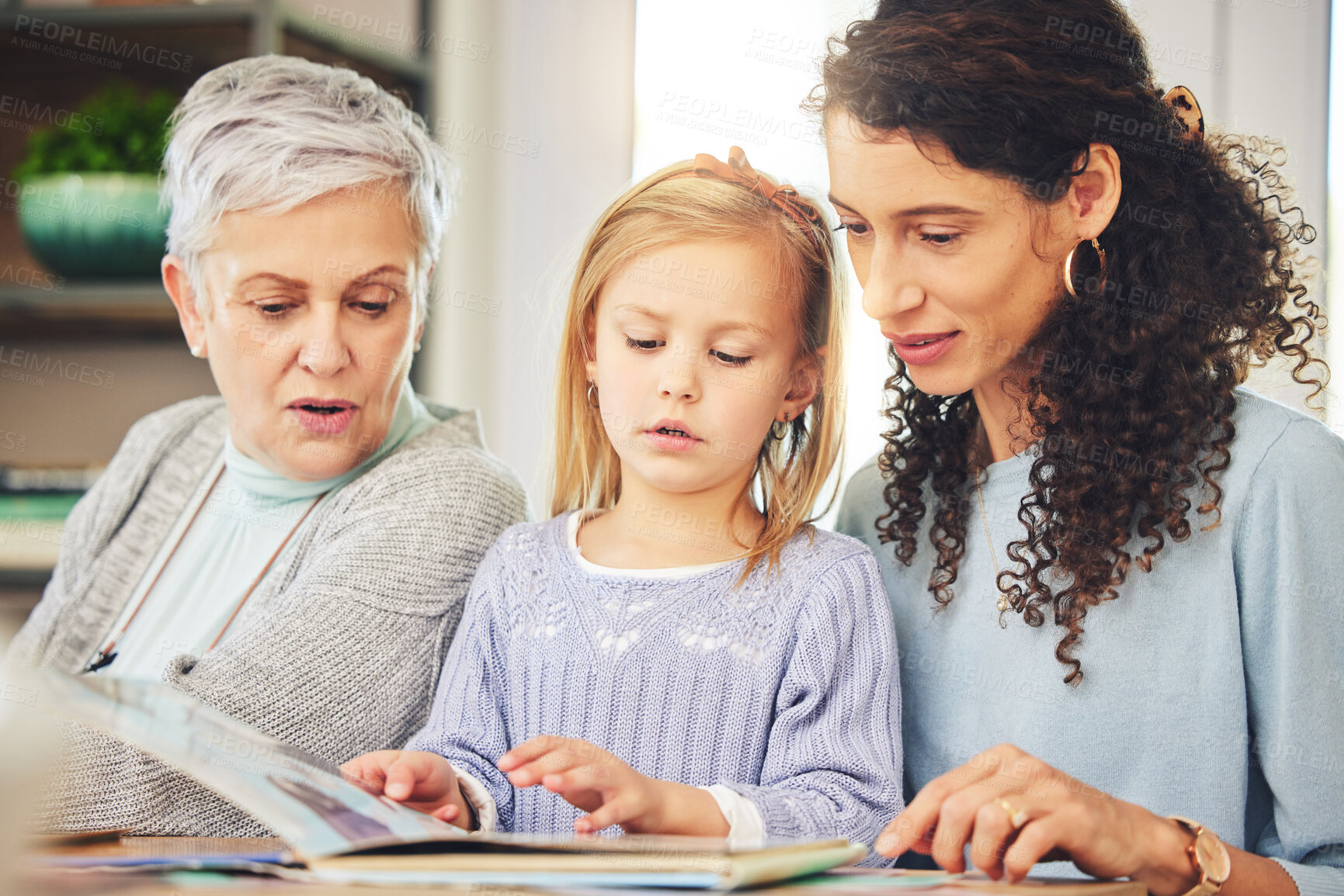 Buy stock photo Grandmother, mama and girl reading a book, bonding and happiness for fun, quality time and relax. Family, parent or granny with mom, daughter or female child with storytelling, literature or learning