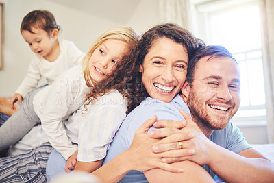 Buy stock photo Family, portrait and happy smile in a home bedroom with children and parents together on bed for quality time. Man and woman or mother and father with children for happiness, love and care in morning