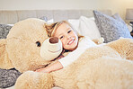 Happy, bedroom and portrait of girl with teddy bear for sleeping, comfortable and happiness at home. Family, child development and female child with fluffy toy in bed for hugging, cozy and bedtime