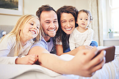 Buy stock photo Family, selfie and smile in a home bedroom with children and parents together on bed for quality time. Man and woman of mother and father with children for a happy profile picture or memory for love